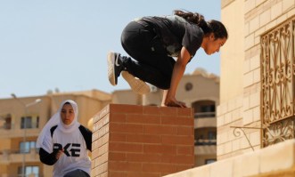 Egyptian women from Parkour Egypt "PKE" practice their parkour skills around buildings on the outskirts of Cairo